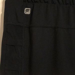 Fabletics black capris with sheer side panels.